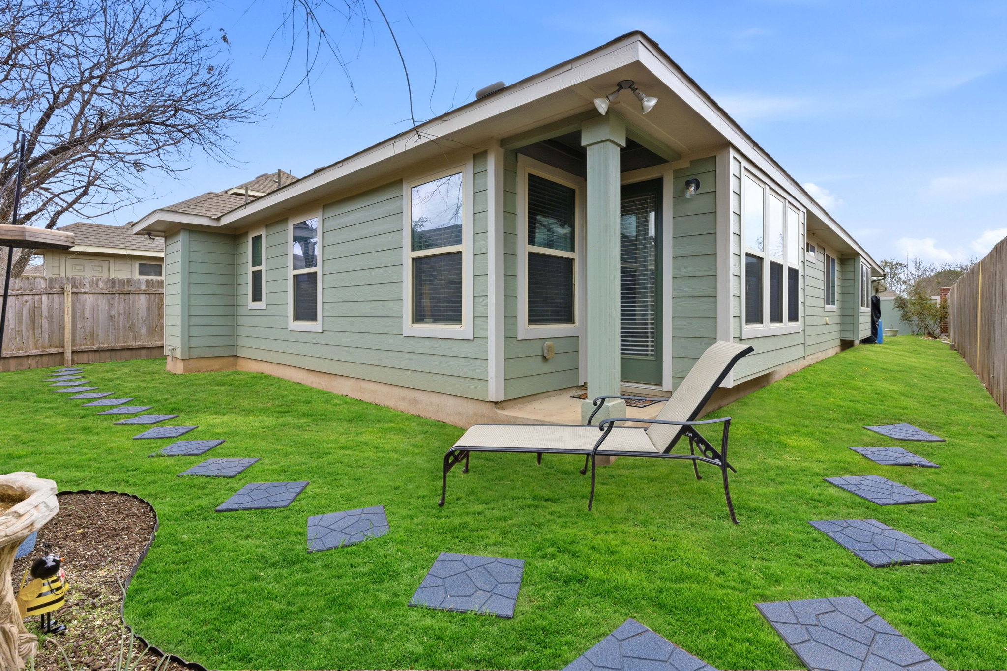 426 Tilly Lane Buda, TX 78610 - Photo 18 of 21 Back of property featuring a fenced backyard and a patio area