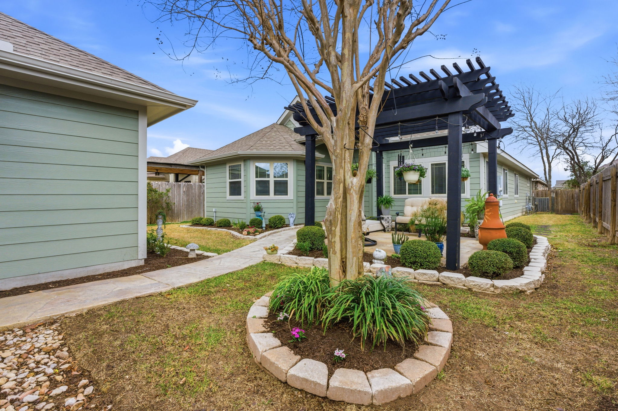 426 Tilly Lane Buda, TX 78610 - Photo 21 of 21 Rear view of house featuring a pergola, a patio area, and a fenced backyard