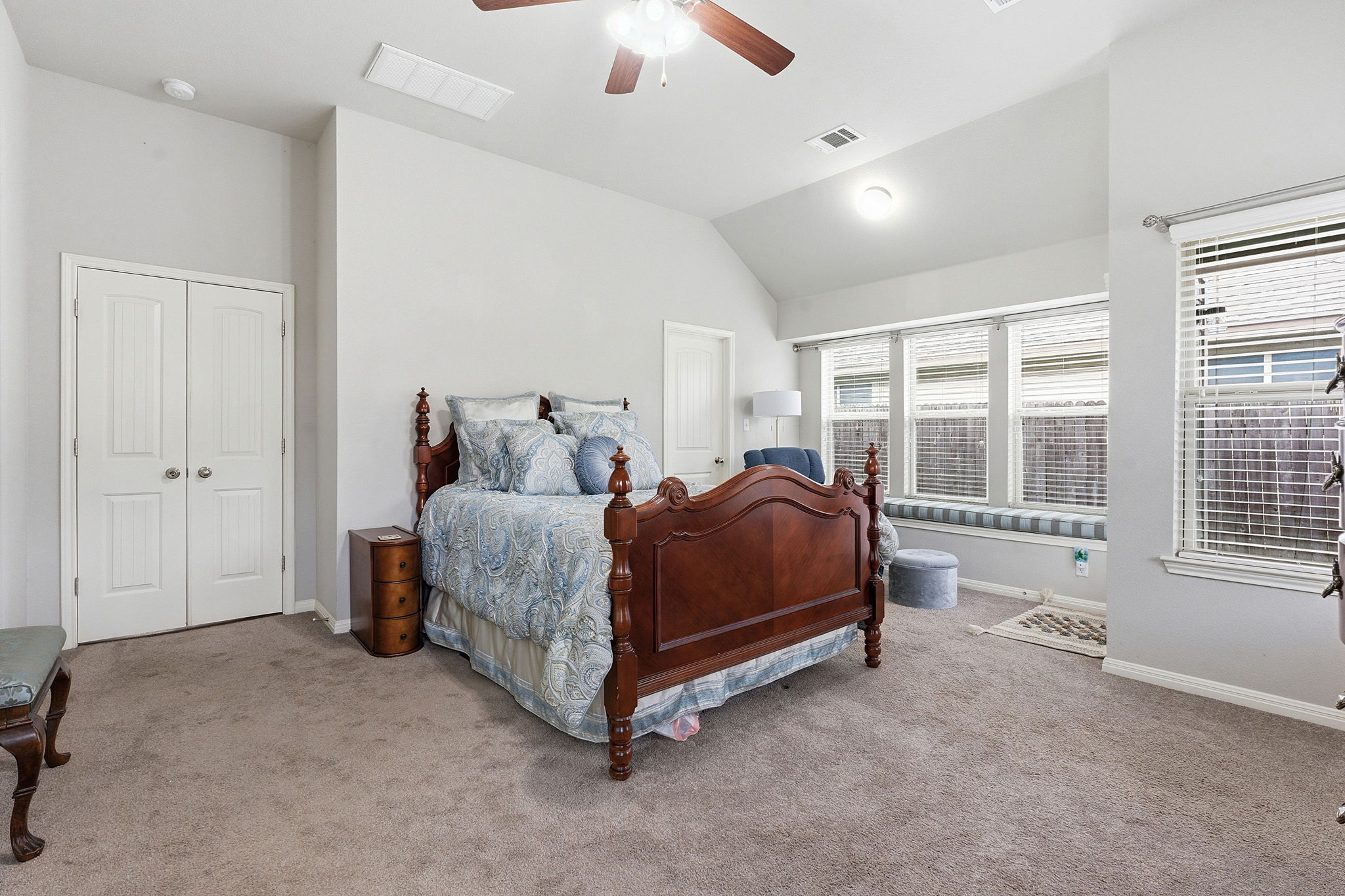 426 Tilly Lane Buda, TX 78610 - Photo 10 of 21 Carpeted bedroom with vaulted ceiling and a ceiling fan