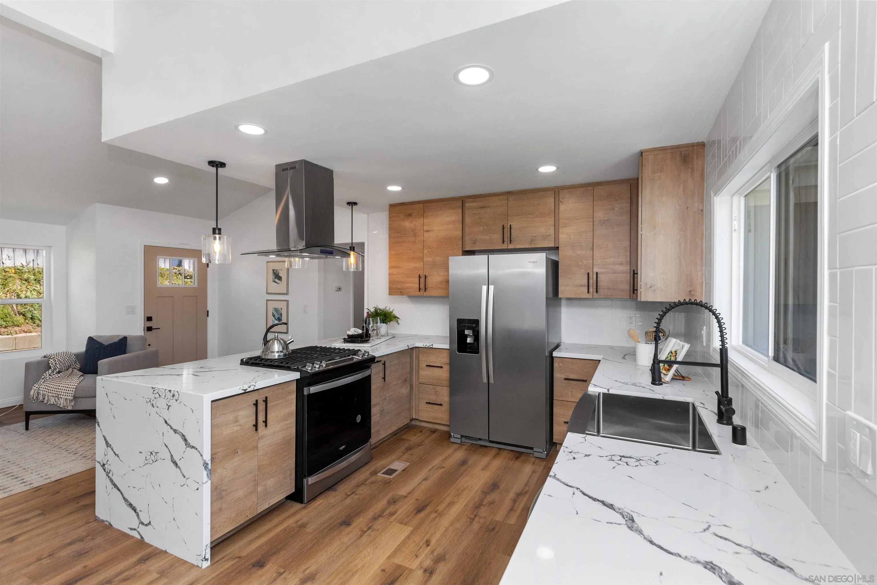 12694 Jackson Heights Drive El Cajon, CA 92021 - Photo 12 of 29 a kitchen that has a refrigerator a table and chairs in it