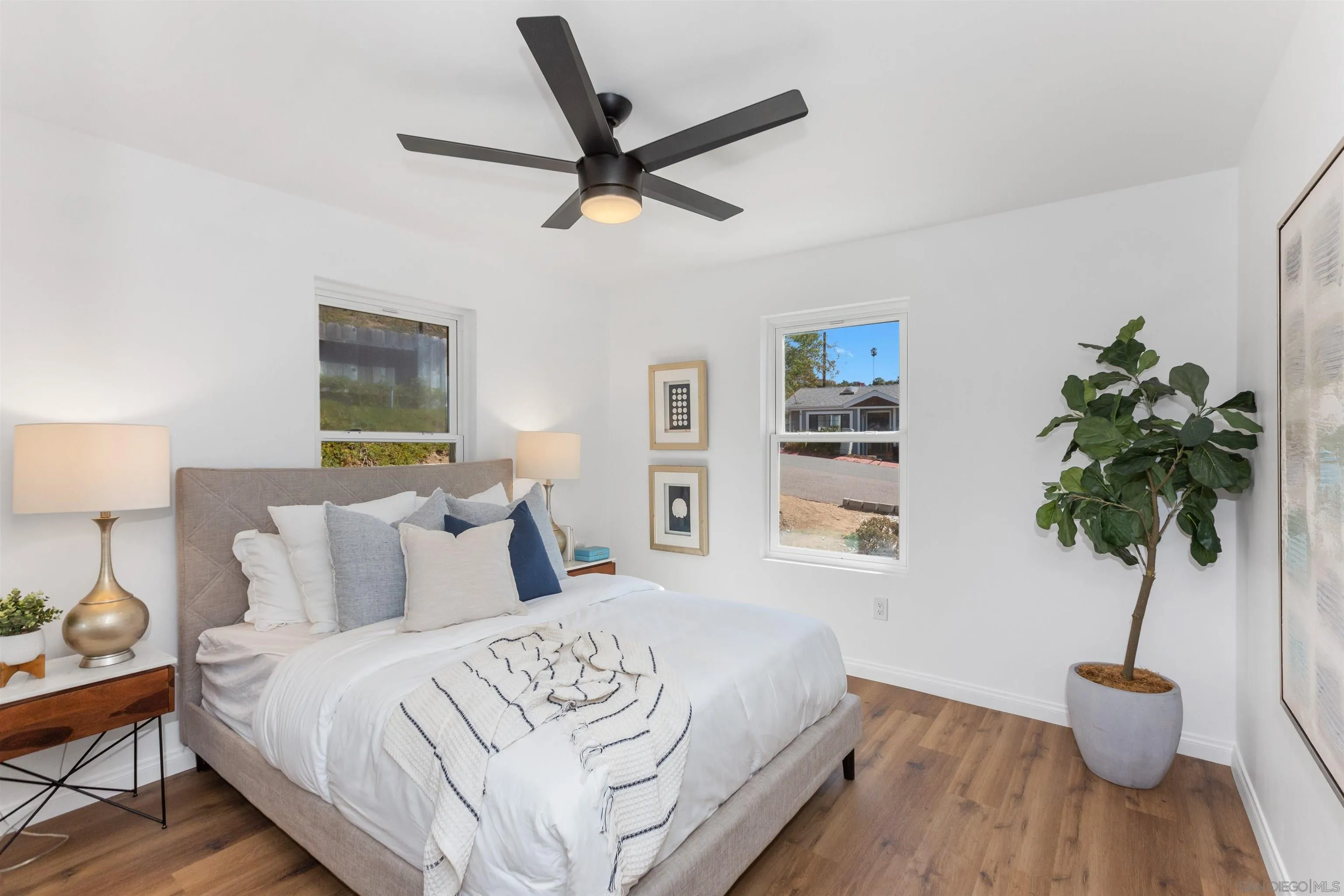 12694 Jackson Heights Drive El Cajon, CA 92021 - Photo 15 of 29 a bedroom with a bed lamp and a potted plant