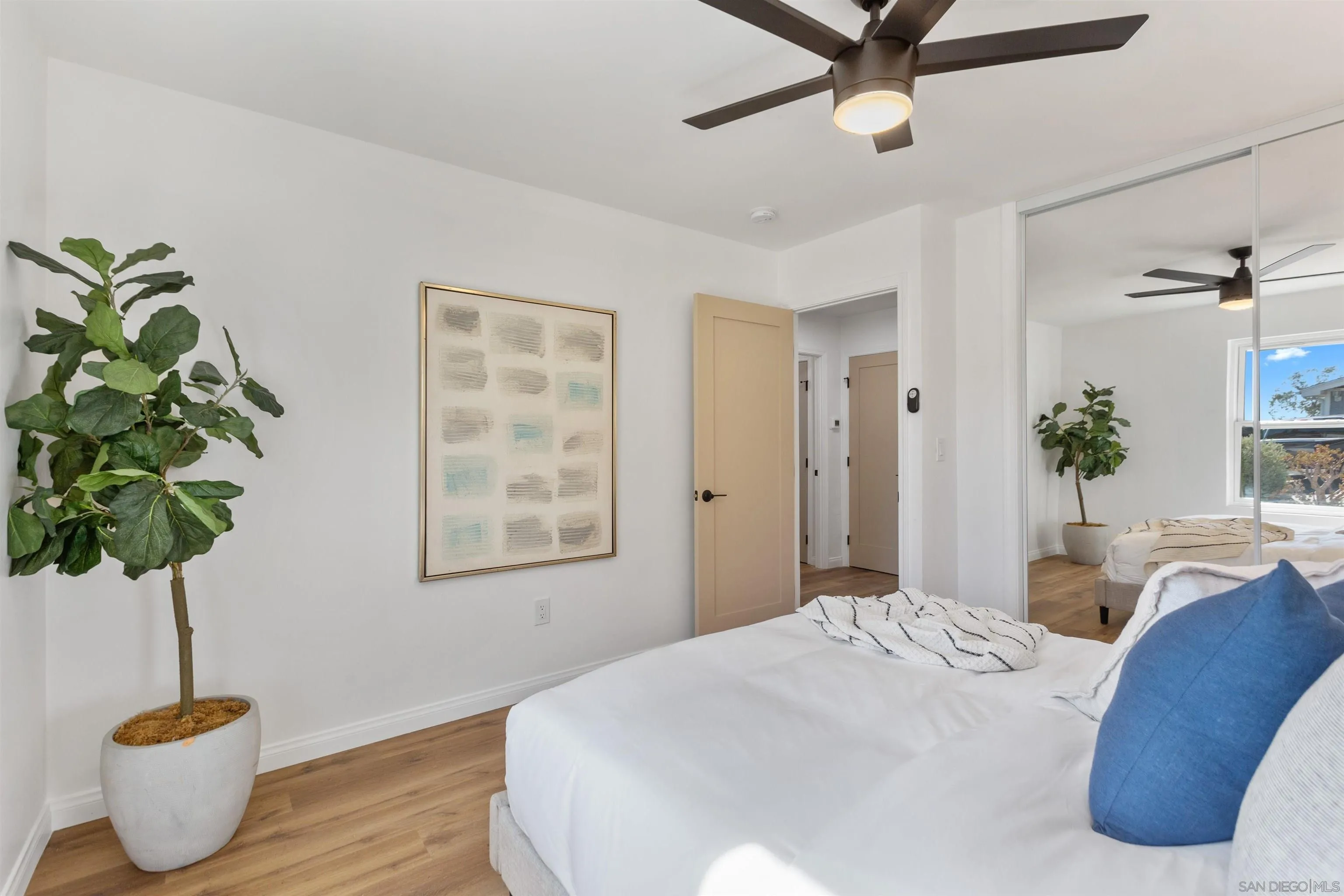 12694 Jackson Heights Drive El Cajon, CA 92021 - Photo 16 of 29 a bedroom with a bed and a potted plant