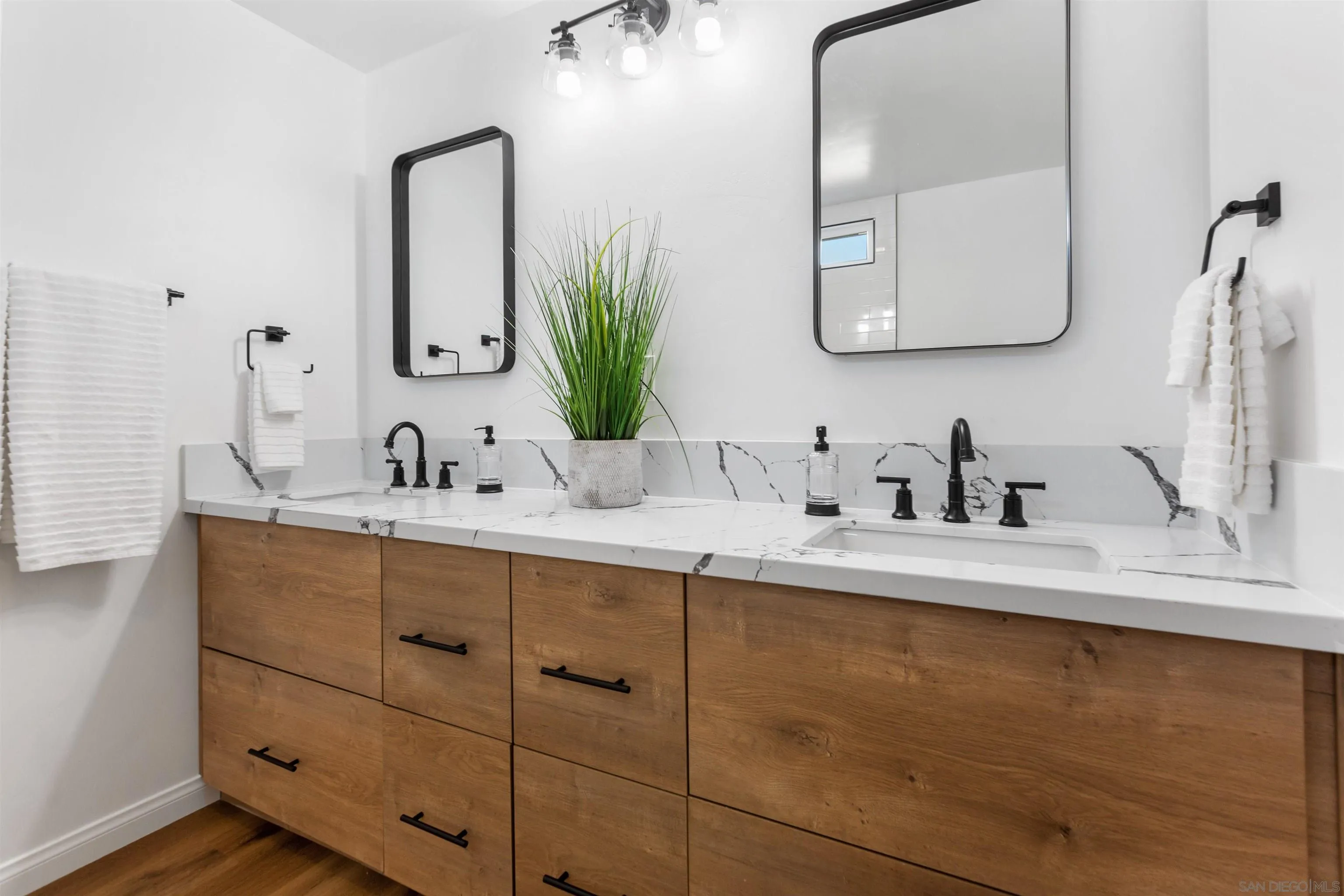 12694 Jackson Heights Drive El Cajon, CA 92021 - Photo 21 of 29 a bathroom with a double vanity sink and mirror
