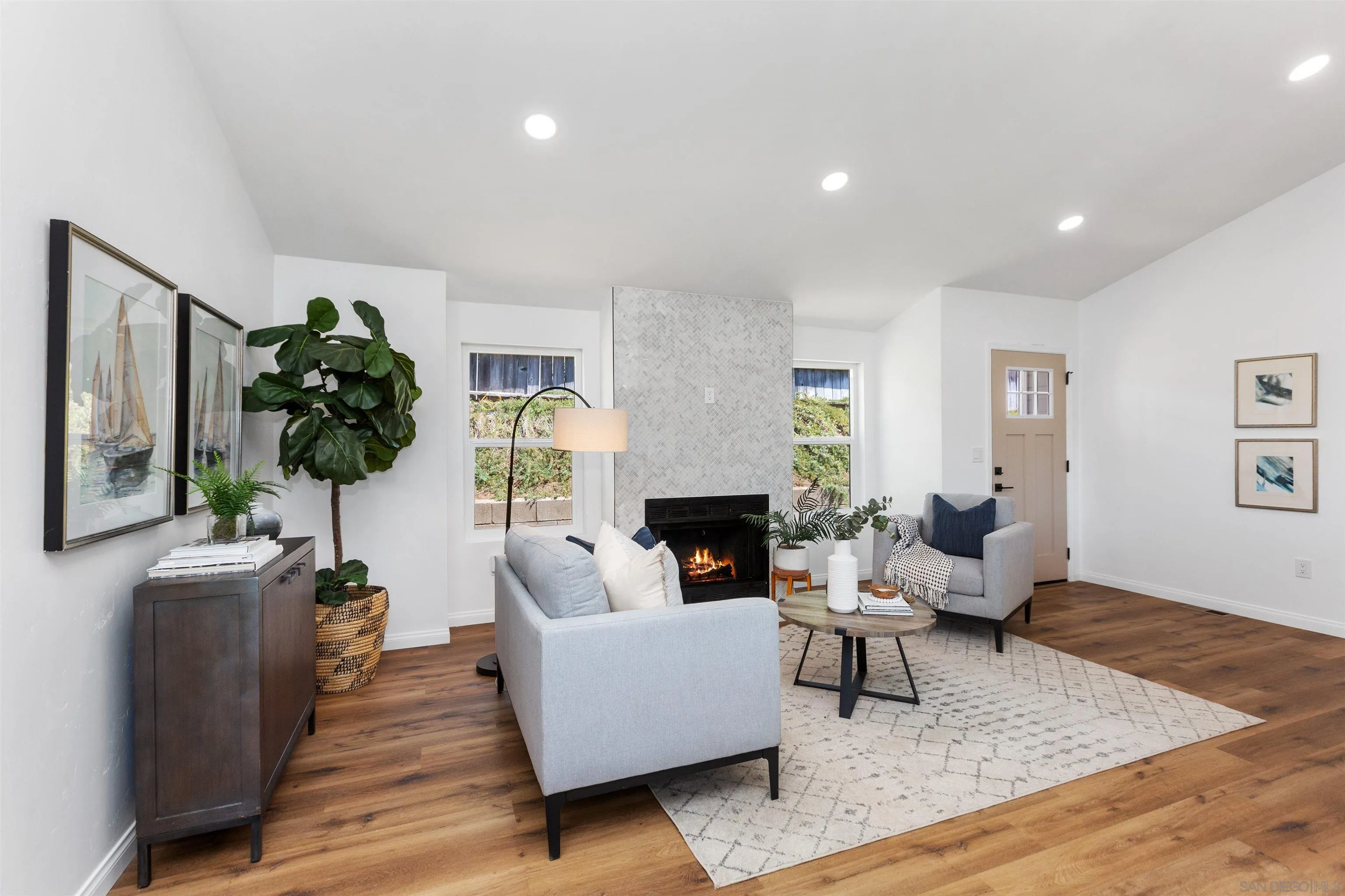 12694 Jackson Heights Drive El Cajon, CA 92021 - Photo 5 of 29 a living room with fireplace furniture and a wooden floor