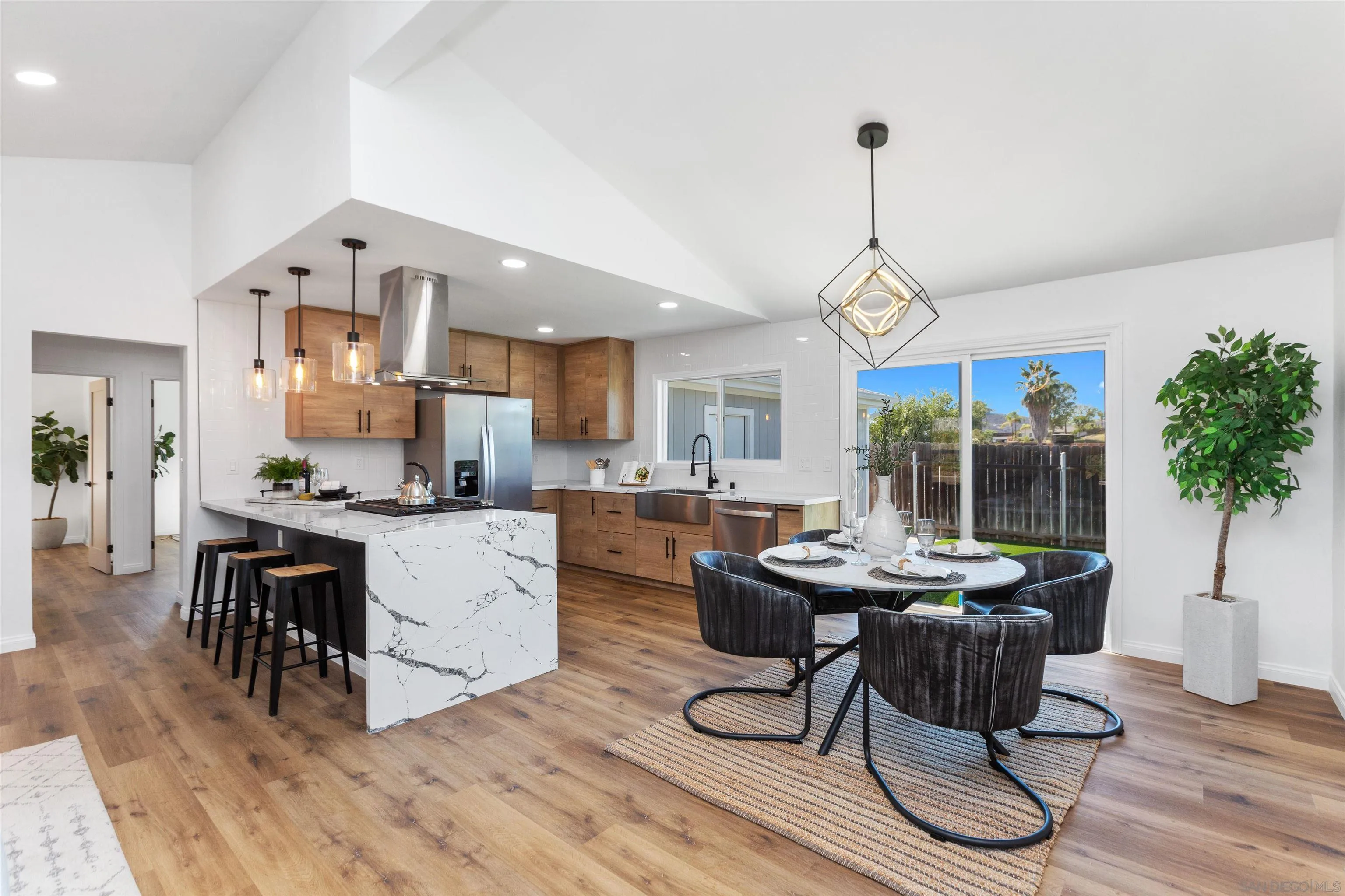 12694 Jackson Heights Drive El Cajon, CA 92021 - Photo 6 of 29 a open dining room with stainless steel appliances kitchen island a table and chairs in it