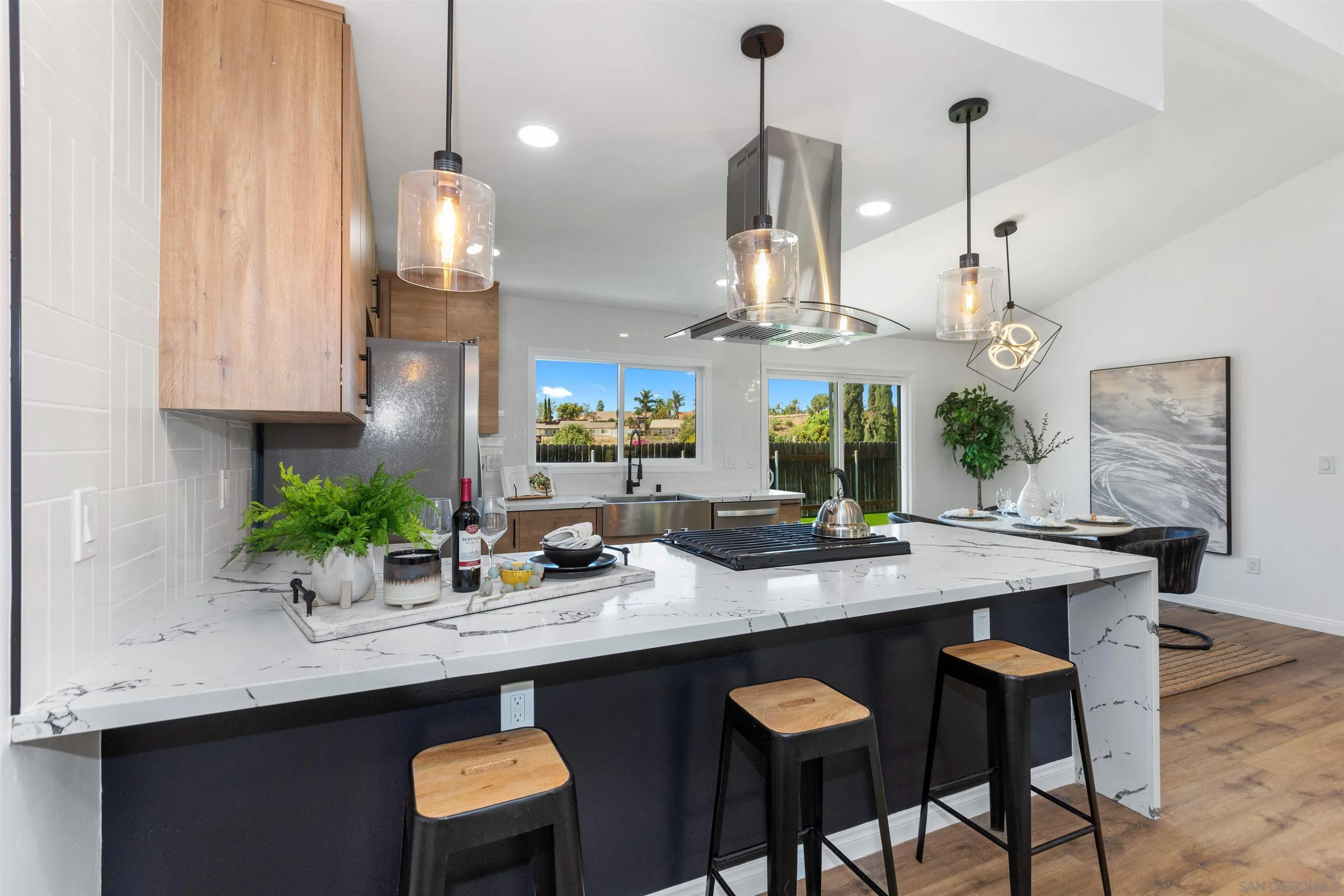 12694 Jackson Heights Drive El Cajon, CA 92021 - Photo 7 of 29 a kitchen with stainless steel appliances granite countertop a sink a stove and a wooden floor