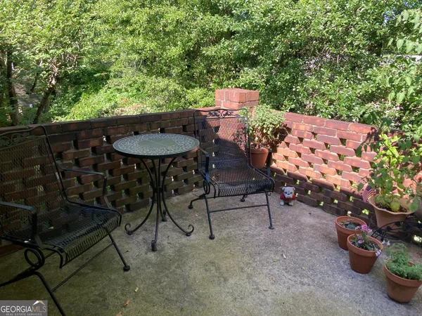 a backyard of a house with table and chairs