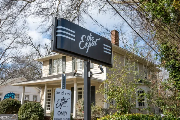 a view of a street sign under a large tree