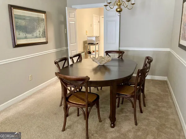 a view of a dining room with furniture and window