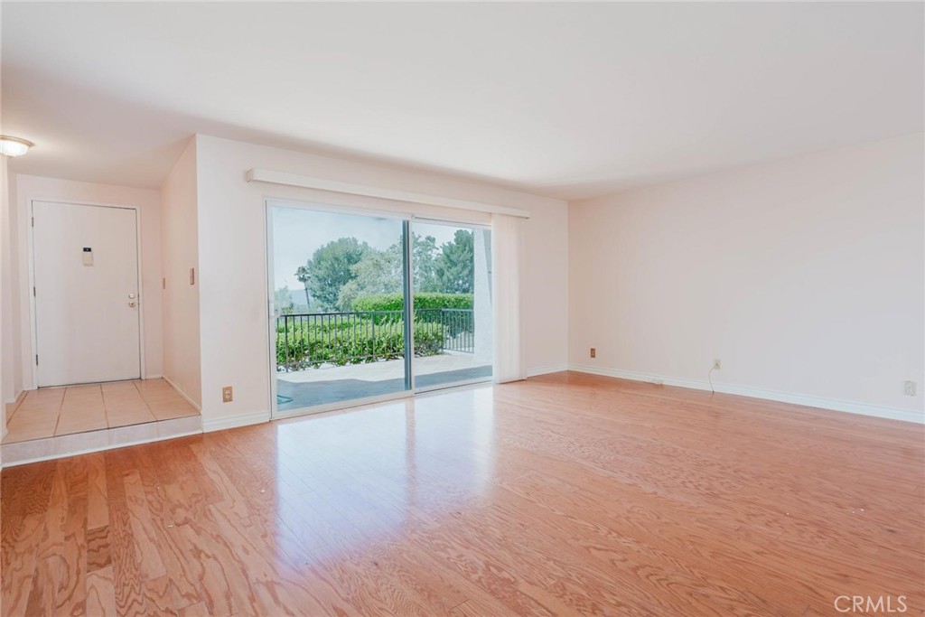 9576 Vía Bernardo Burbank, CA 91504 - Photo 3 of 38 a view of an empty room with wooden floor and a window