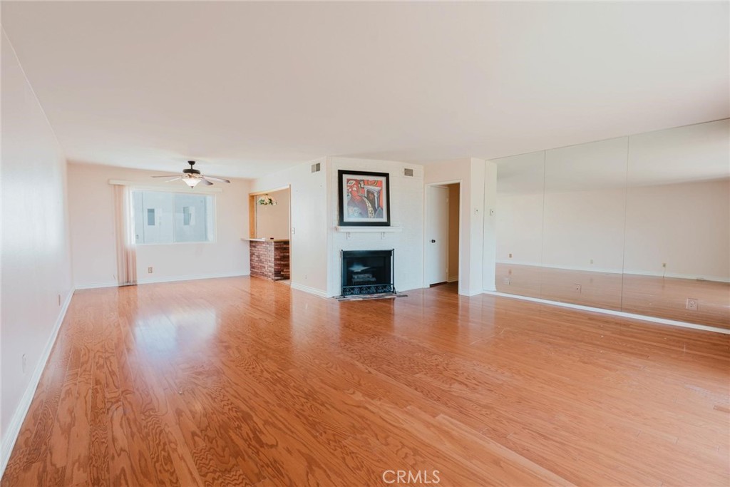 9576 Vía Bernardo Burbank, CA 91504 - Photo 7 of 38 a view of a livingroom with wooden floor and a fireplace