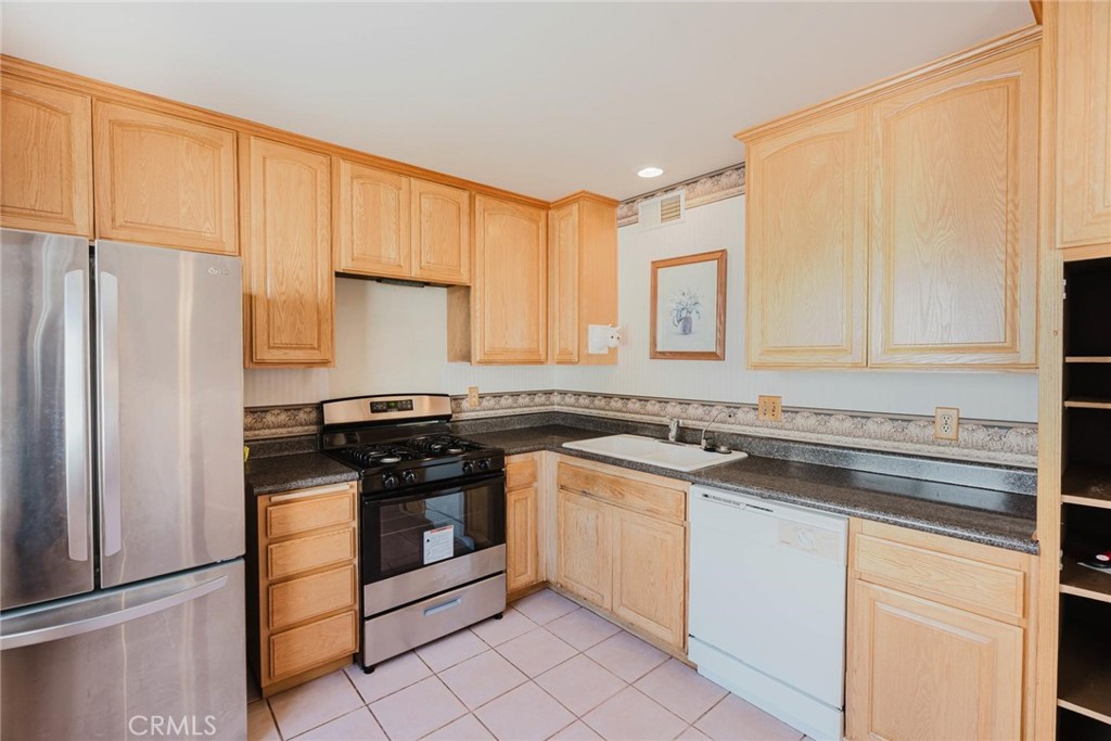 9576 Vía Bernardo Burbank, CA 91504 - Photo 10 of 38 a kitchen with stainless steel appliances granite countertop a stove a sink and a refrigerator