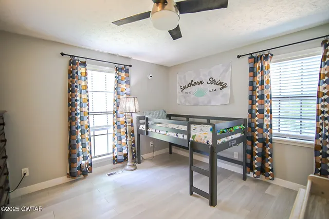 a bedroom with a bed a flat screen tv and a couch