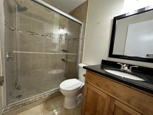 an empty room with closet and a bathroom