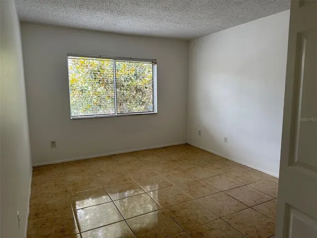 a view of wooden floor and windows in an empty room