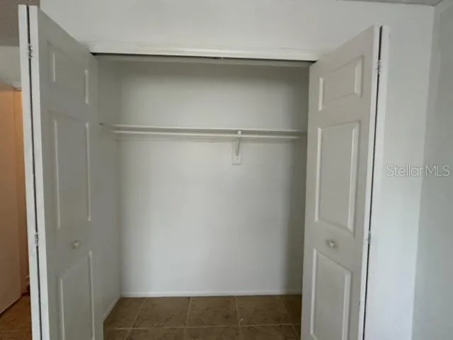 a view of a room with wooden floor and outdoor view