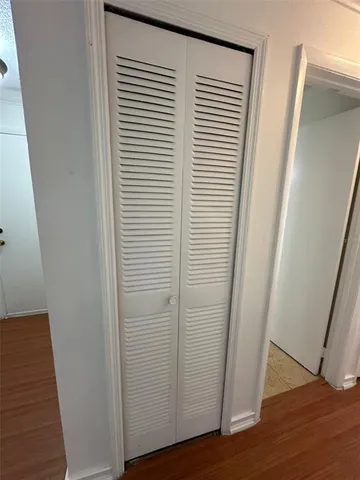 a room with a stove and white cabinet