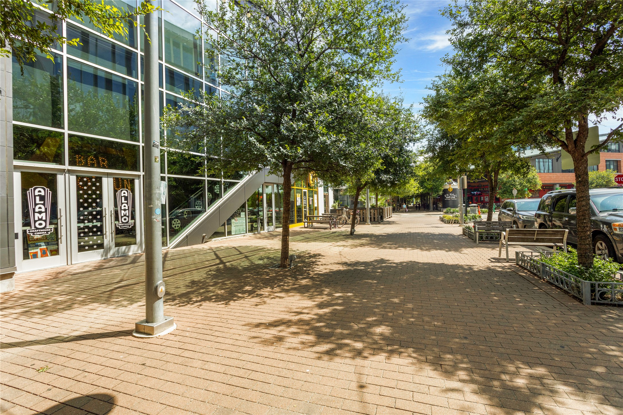 2805 McCurdy Street, Unit 14 Austin, TX 78723 - Photo 33 of 40 A vibrant streetscape with a brick paved walkway and lush green trees by Alamo Drafthouse Movie Theatre