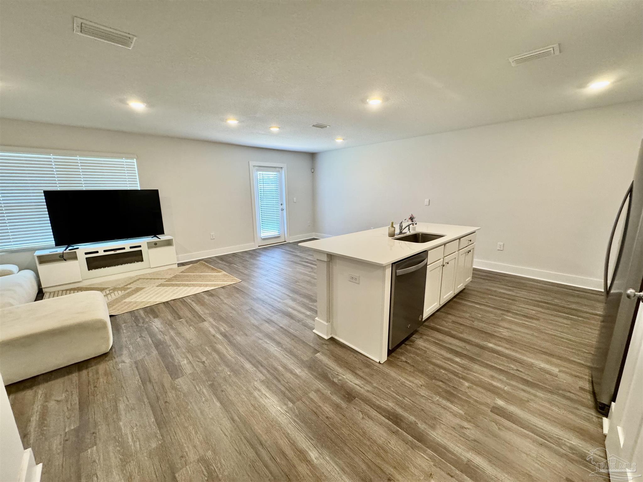 3312 Harrier Road Pace, FL 32571 - Photo 16 of 35 a kitchen with a sink and wooden floor