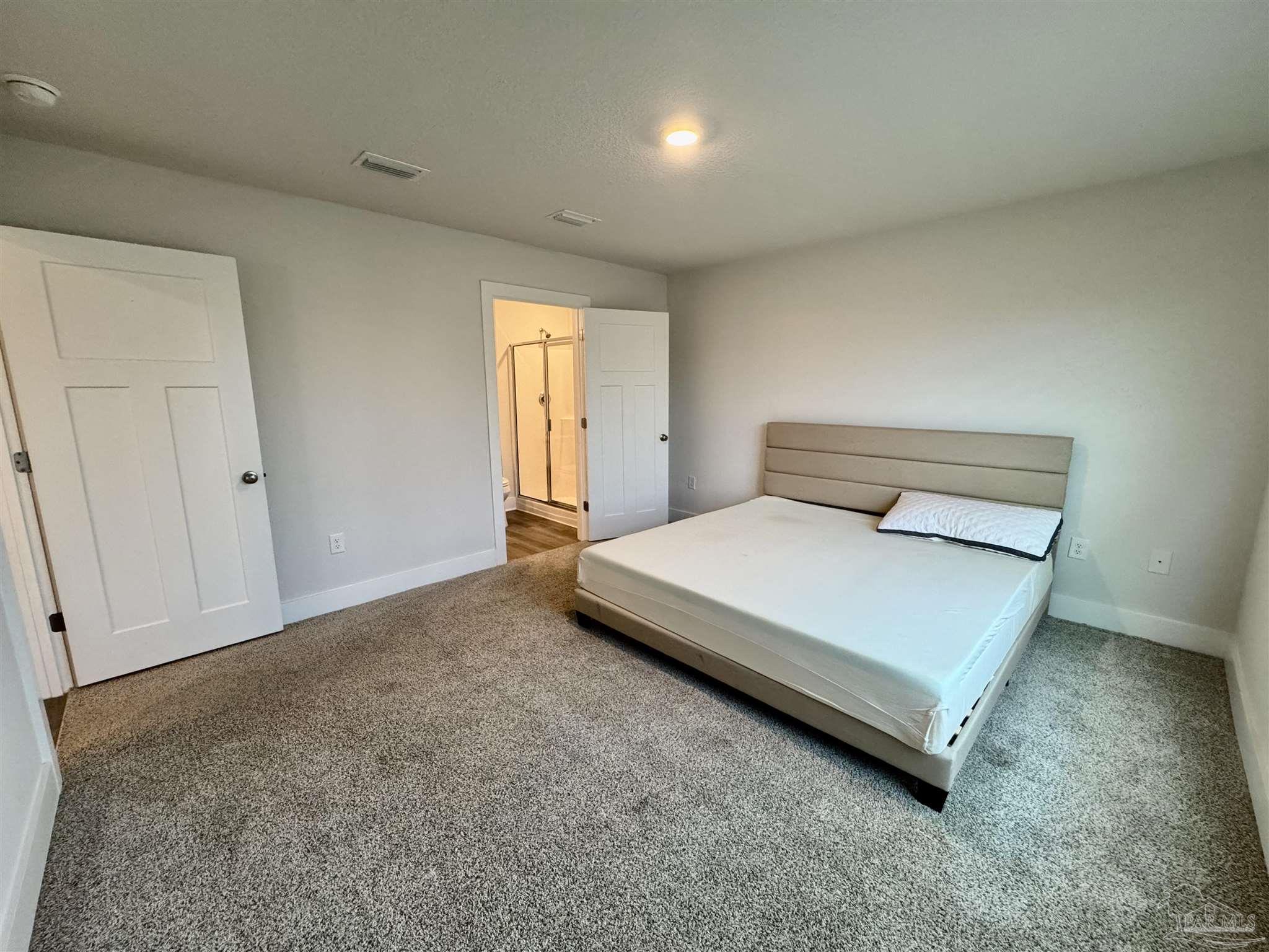 3312 Harrier Road Pace, FL 32571 - Photo 25 of 35 a bed sitting in a room next to a window