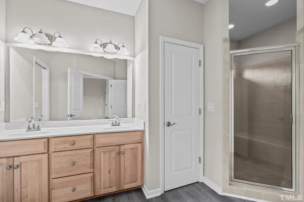 a bathroom with a double vanity sink and a mirror