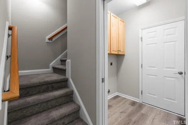a view of entryway with wooden floor and stairs