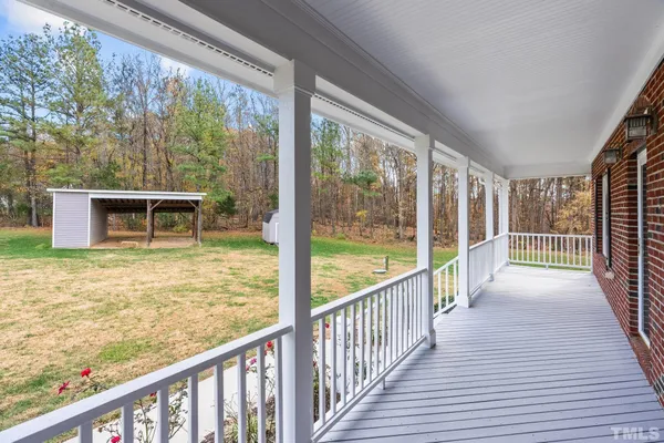 a view of a balcony with wooden floor