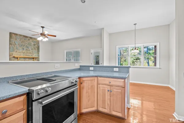a kitchen with a stove a sink and a window