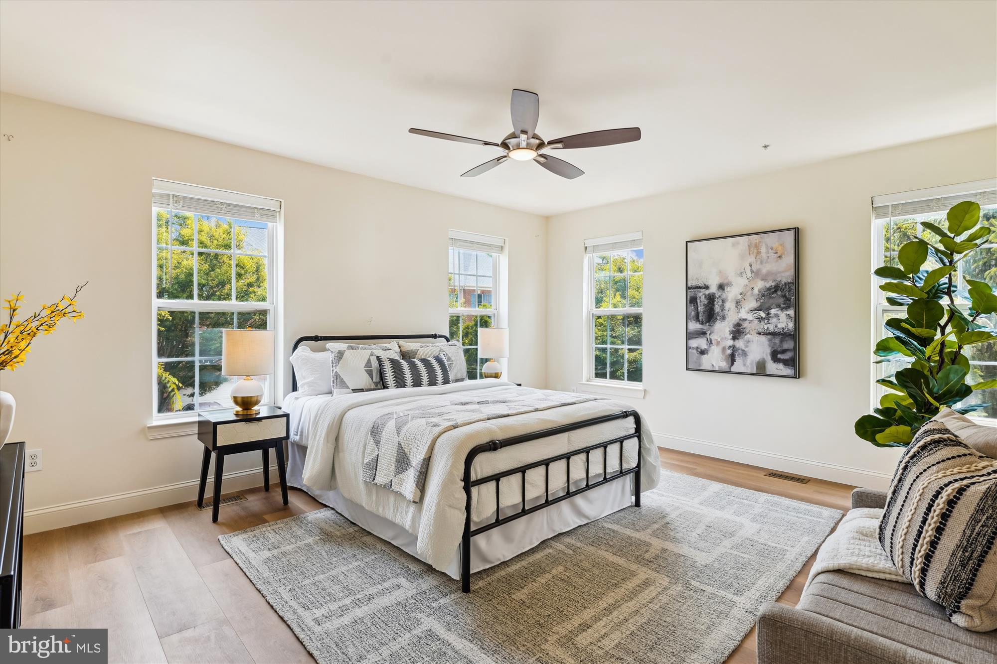 604 Highland Ridge Avenue, Unit 100 Gaithersburg, MD 20878 - Photo 17 of 46 a spacious bedroom with a bed a painting and a window