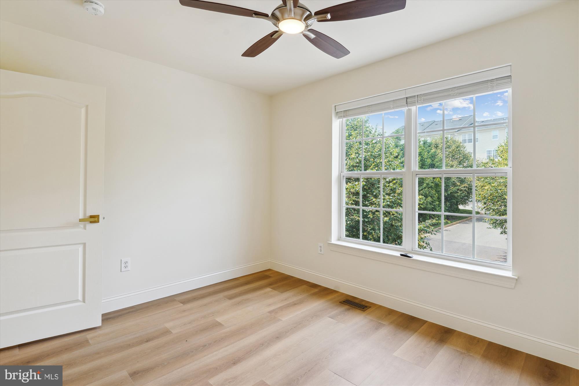 604 Highland Ridge Avenue, Unit 100 Gaithersburg, MD 20878 - Photo 23 of 46 a view of a livingroom with a ceiling fan and window