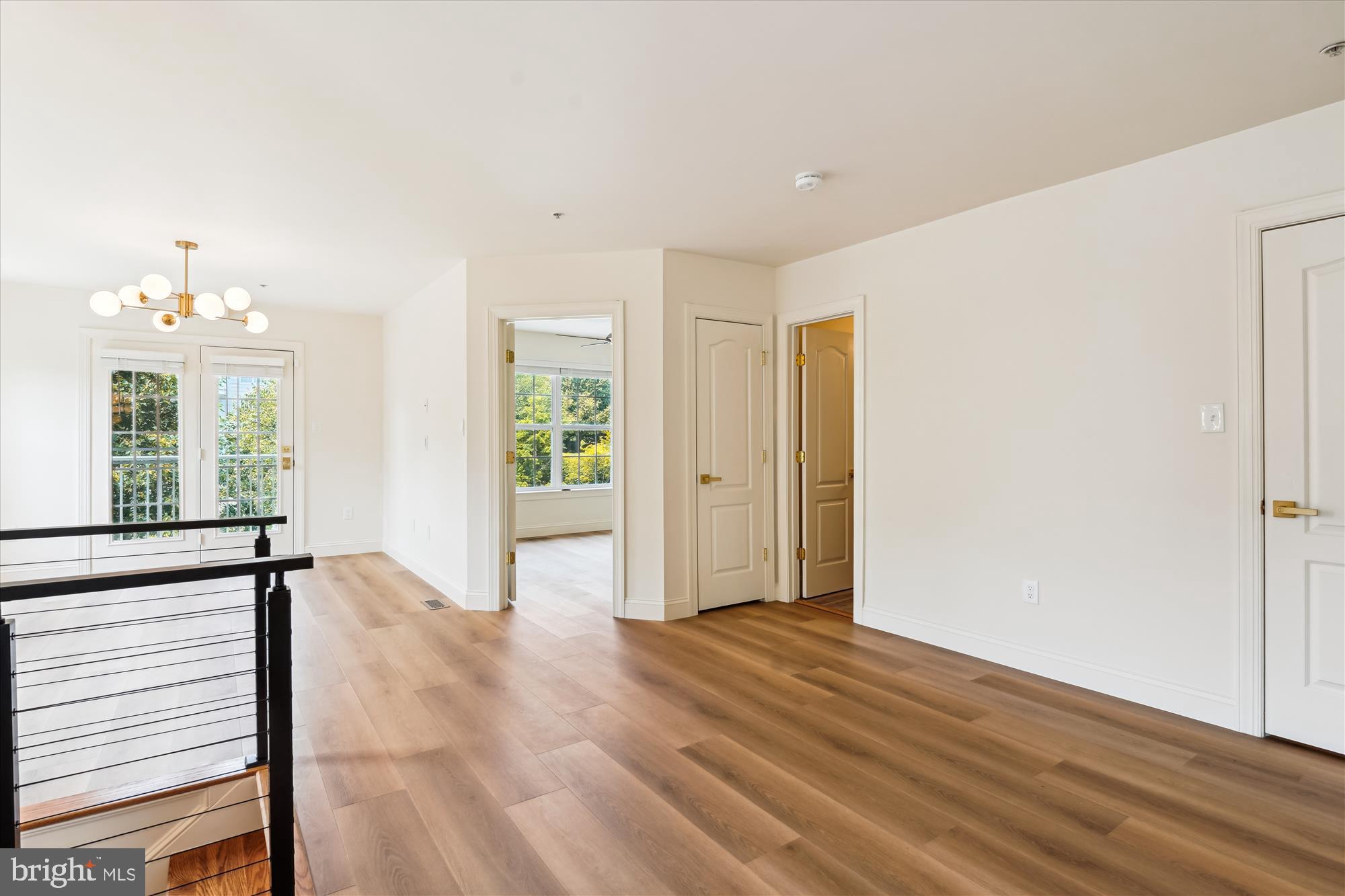 604 Highland Ridge Avenue, Unit 100 Gaithersburg, MD 20878 - Photo 32 of 46 a view of an empty room with wooden floor and a window