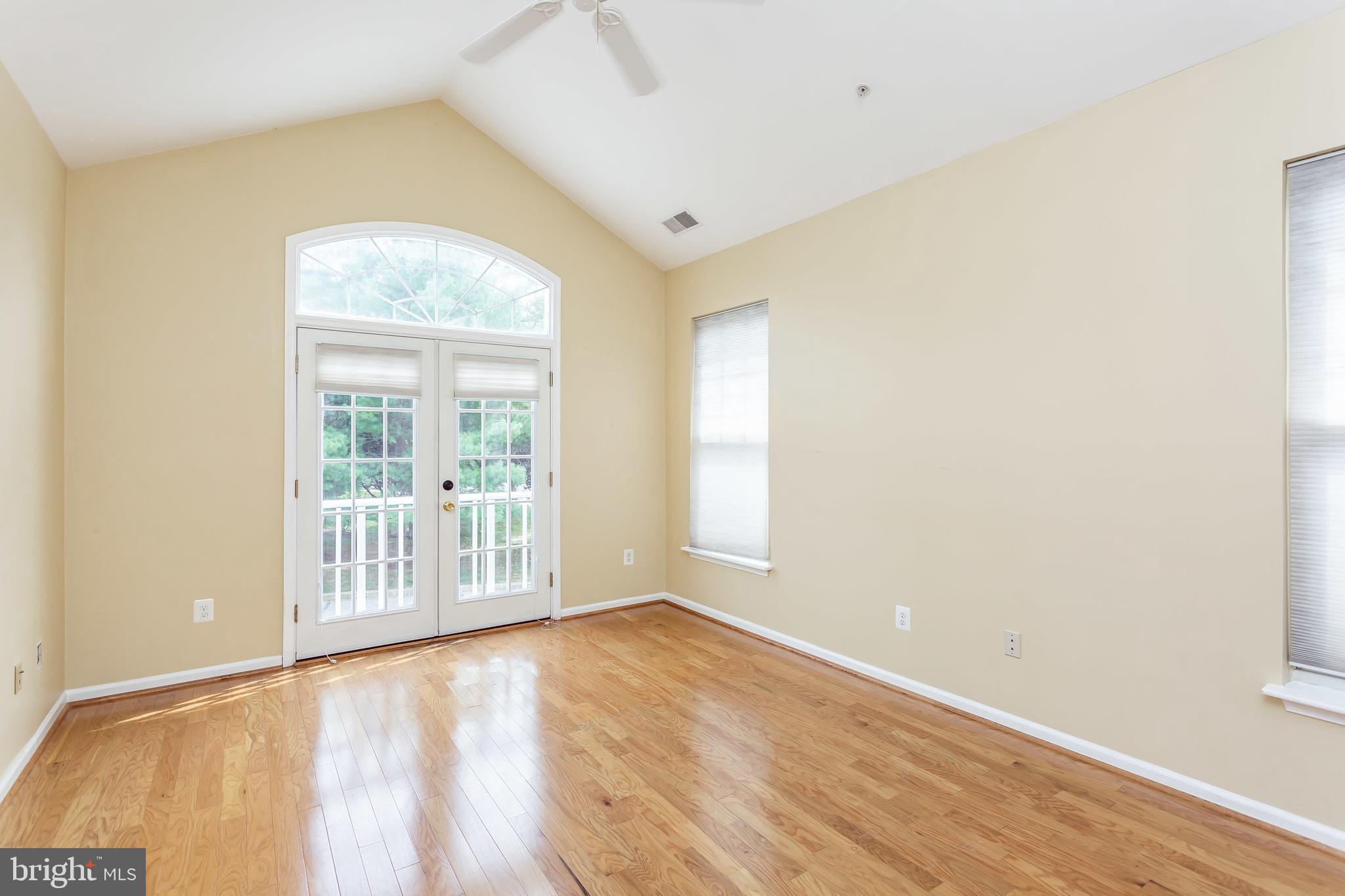 52 Barbican Way, Unit 52 Baltimore, MD 21208 - Photo 16 of 29 an empty room with wooden floor and windows