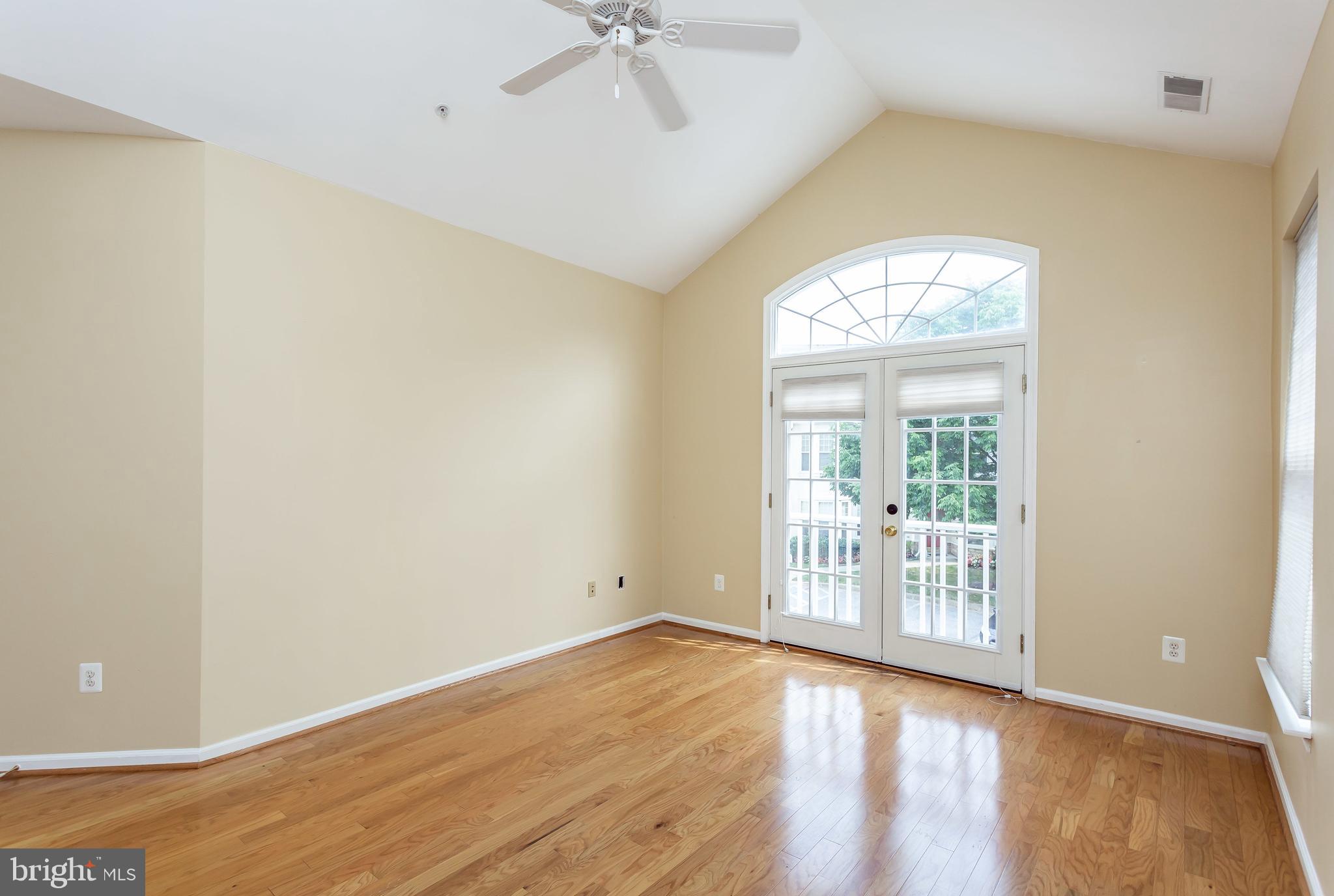 52 Barbican Way, Unit 52 Baltimore, MD 21208 - Photo 17 of 29 an empty room with wooden floor fan and windows