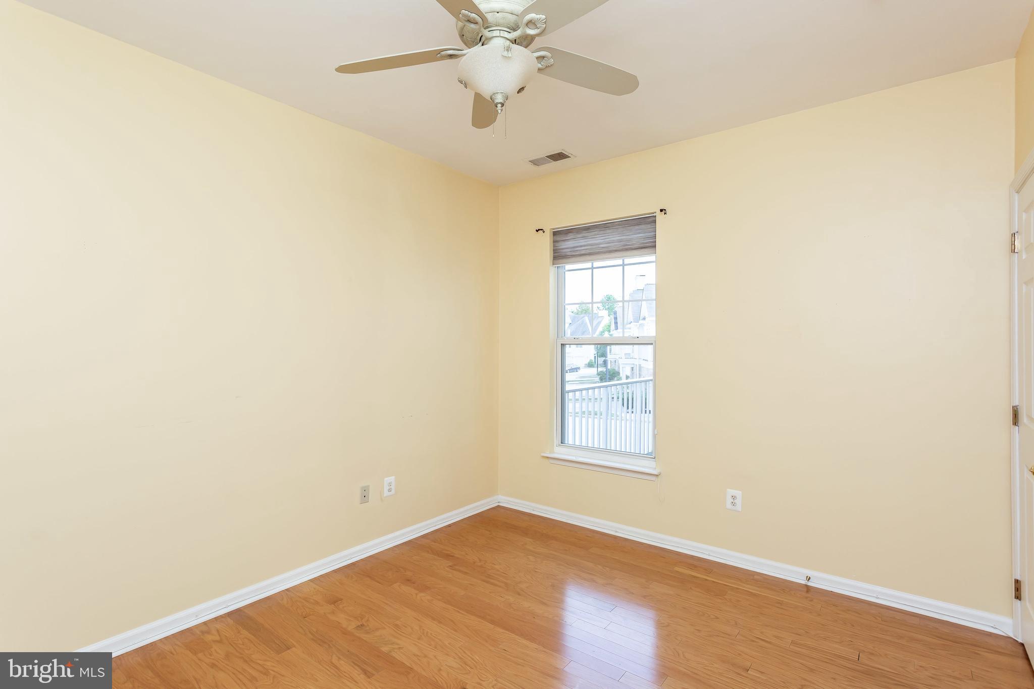 52 Barbican Way, Unit 52 Baltimore, MD 21208 - Photo 26 of 29 an empty room with windows and fan