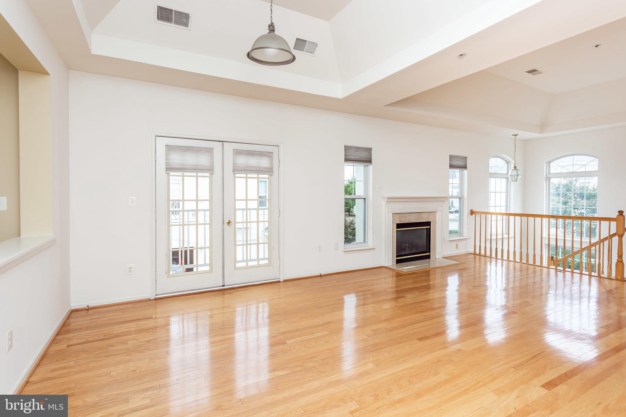 52 Barbican Way, Unit 52 Baltimore, MD 21208 - Photo 8 of 29 a view of an empty room with wooden floor and a window