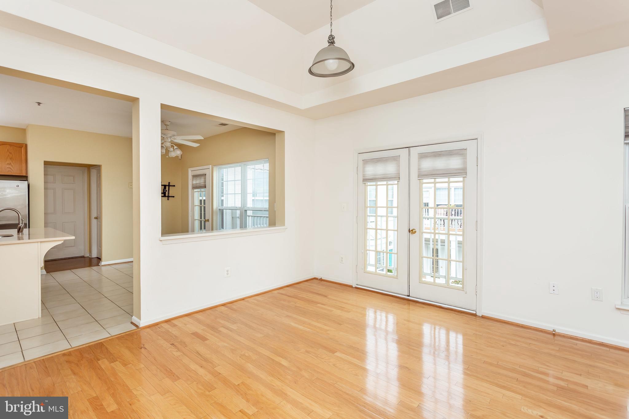 52 Barbican Way, Unit 52 Baltimore, MD 21208 - Photo 9 of 29 a view of an empty room with wooden floor and a window