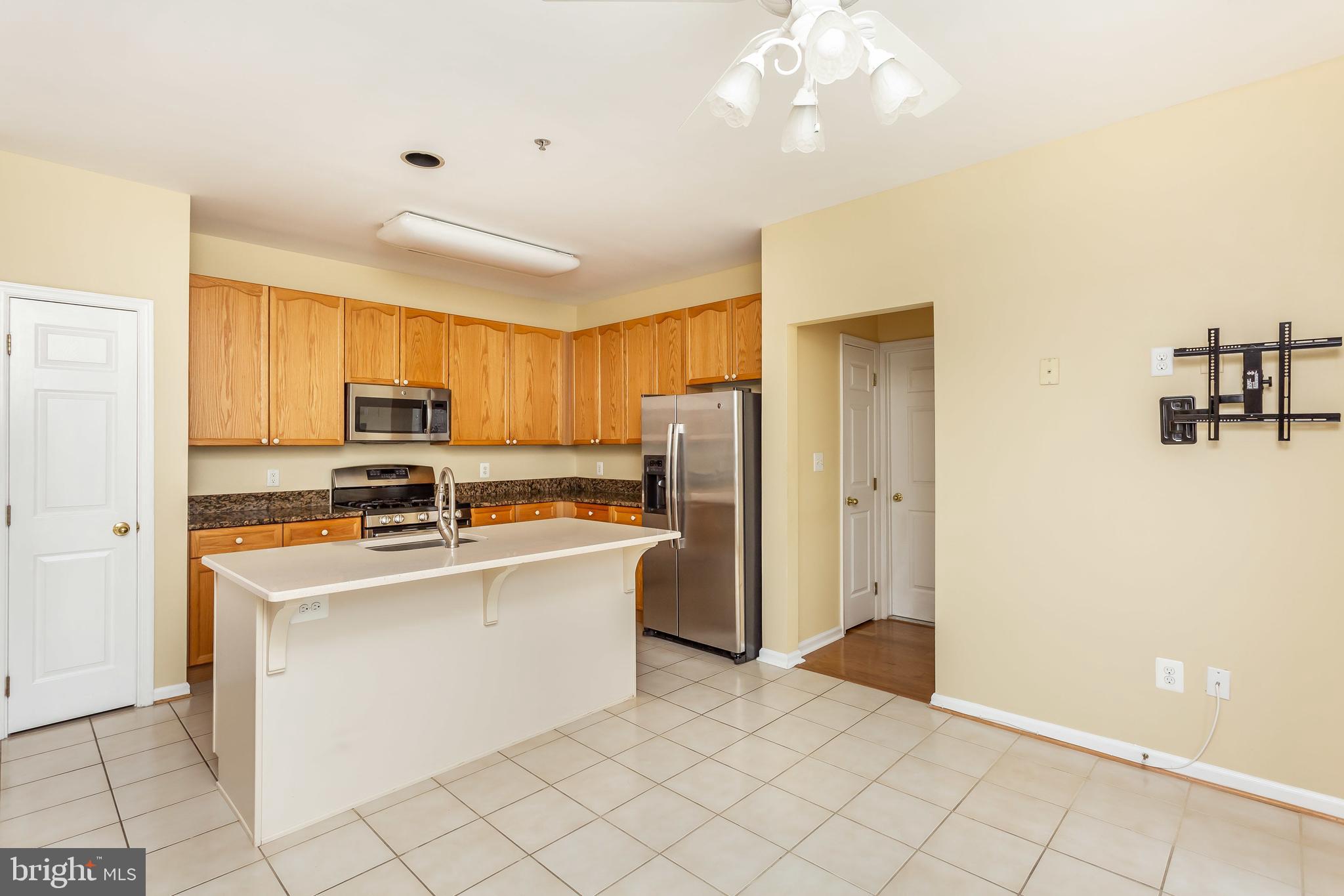 52 Barbican Way, Unit 52 Baltimore, MD 21208 - Photo 10 of 29 a kitchen with stainless steel appliances a stove refrigerator sink and microwave