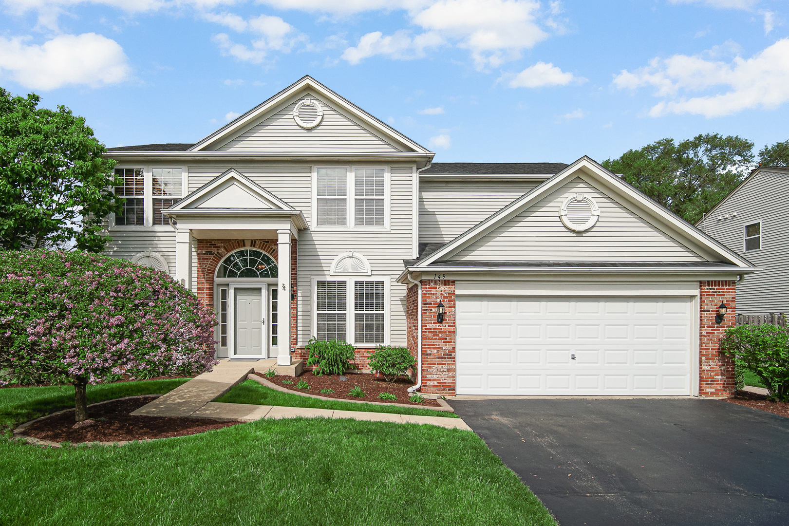 149 Lilac Street Bolingbrook, IL 60490 - Photo 1 of 3 a front view of a house with a yard and garage