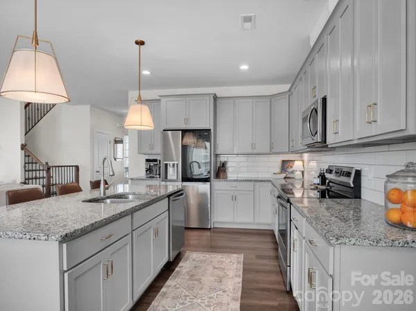 a kitchen with a sink a counter space cabinets and stainless steel appliances