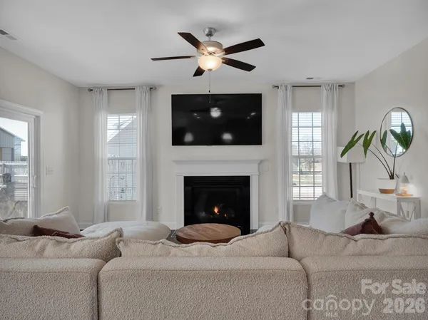 a living room with furniture a fireplace and a flat screen tv