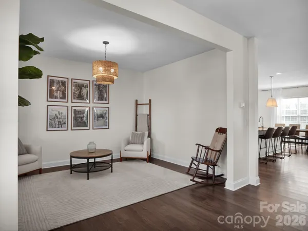 a living room with furniture a dining table and a piano table with wooden floor