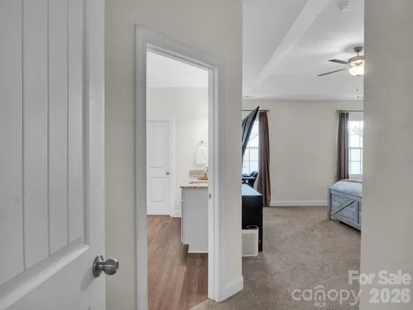a bathroom with a granite countertop sink and mirror
