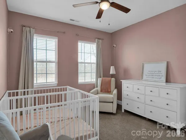 a living room with furniture a air conditioner and a window
