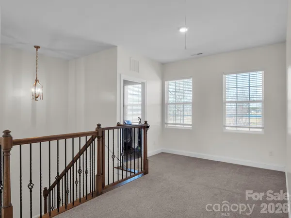 a view of a house with a yard covered with snow