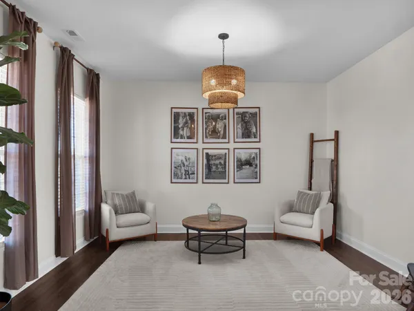 a living room with furniture and a chandelier