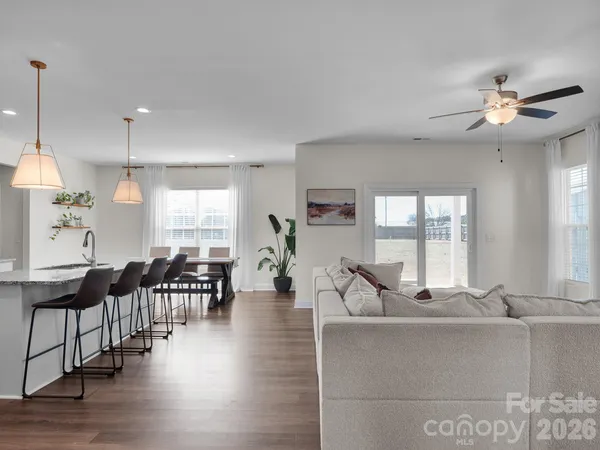 a living room with furniture dining table and a large window