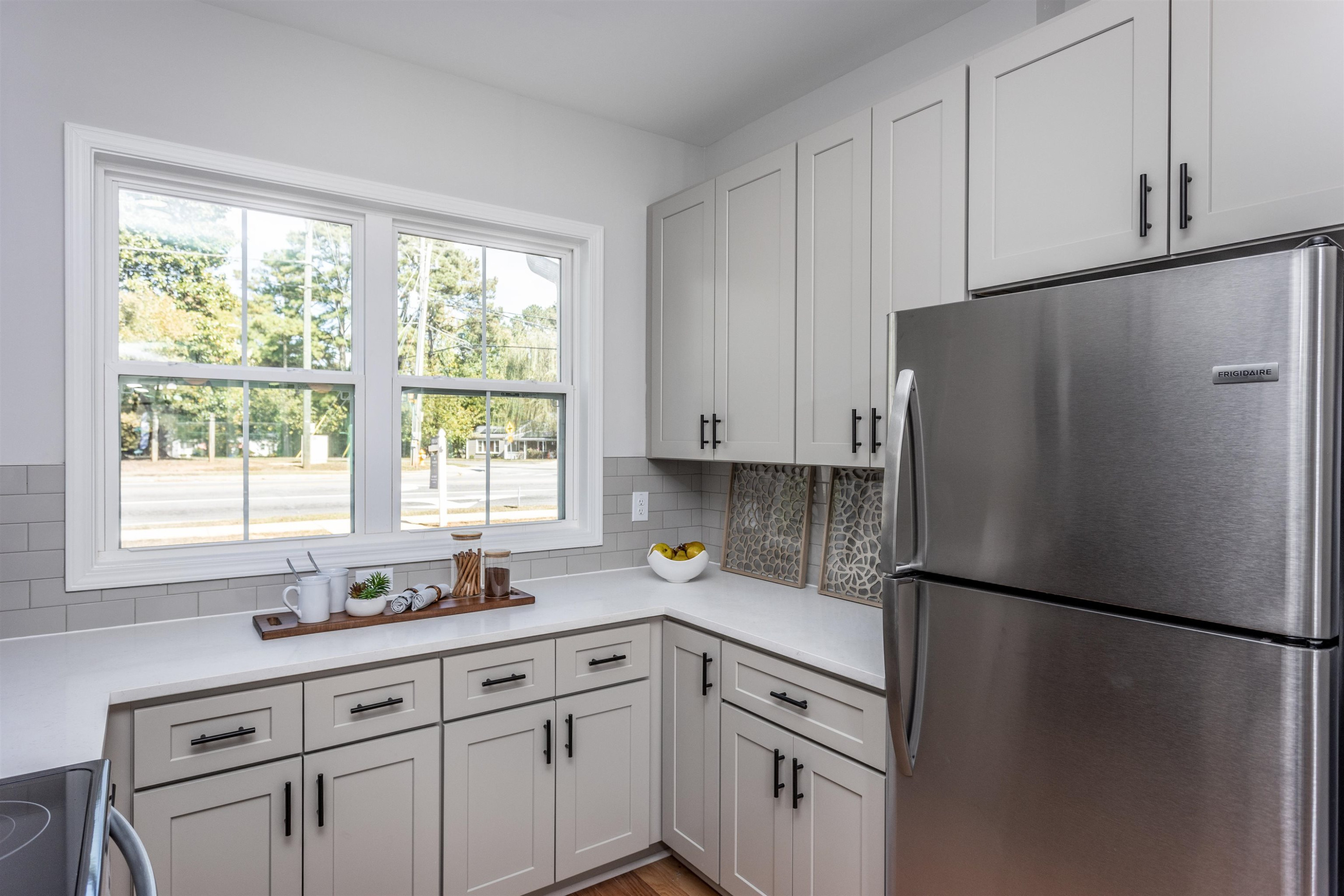 626 Rush Street Raleigh, NC 27610 - Photo 6 of 26 a kitchen with a refrigerator a sink and cabinets