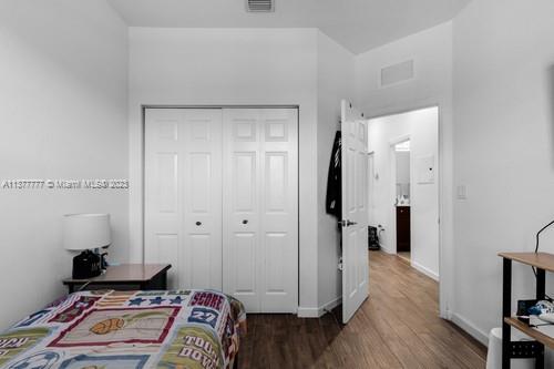 3772 Southeast 2nd Drive, Unit 3772 Homestead, FL 33033 - Photo 16 of 36 a bedroom with a bed and wooden floor