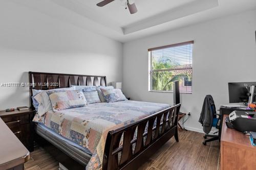 3772 Southeast 2nd Drive, Unit 3772 Homestead, FL 33033 - Photo 18 of 36 a bedroom with a bed a flat screen tv and a window