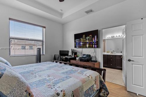 3772 Southeast 2nd Drive, Unit 3772 Homestead, FL 33033 - Photo 19 of 36 a bedroom with a bed and a flat screen tv